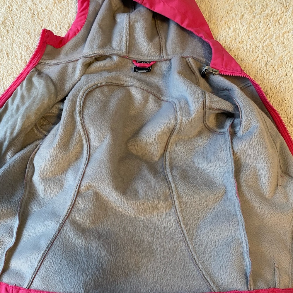 Pink zip-up jacket.